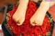 A woman's feet in a box of red roses.