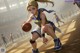 A girl in a blue and yellow uniform dribbling a basketball.