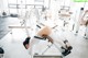 A woman is doing a bench press in a gym.